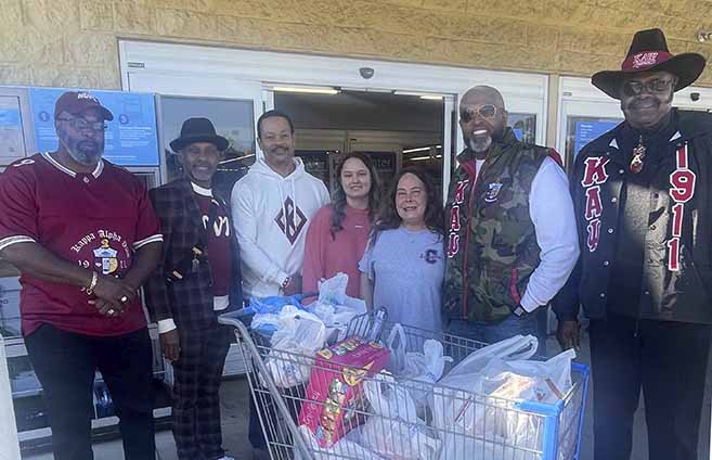 At one of the shopping locations, from left, Alfred Johnson, Robert Goler, Kevin Simmons, Recipients, Dr. Vinson Bradley (President), and Harold ‘Boo’ Dailey 